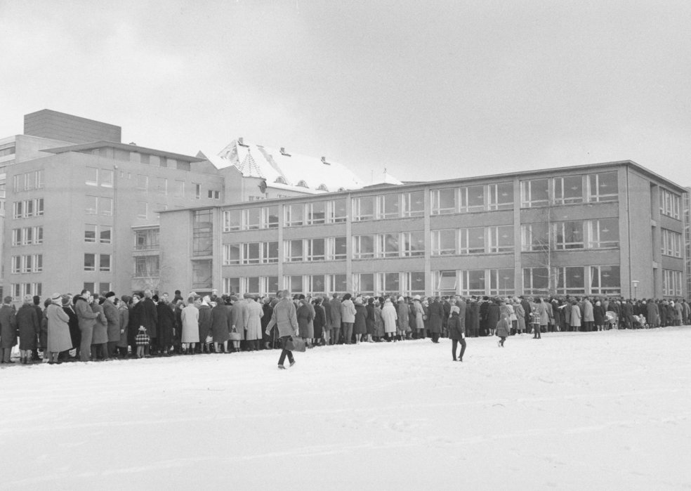 Queues of people waiting for border passes in front of a West Berlin school, December 1963