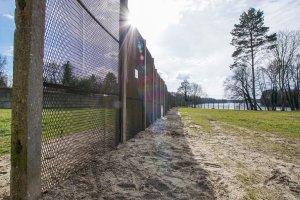 Drei Meter hoher Sperrzaun aus Streckmetallgitterplatten als vorderes Sperrelement der DDR-Grenzanlagen am Groß Glienicker See; Aufnahme 2015