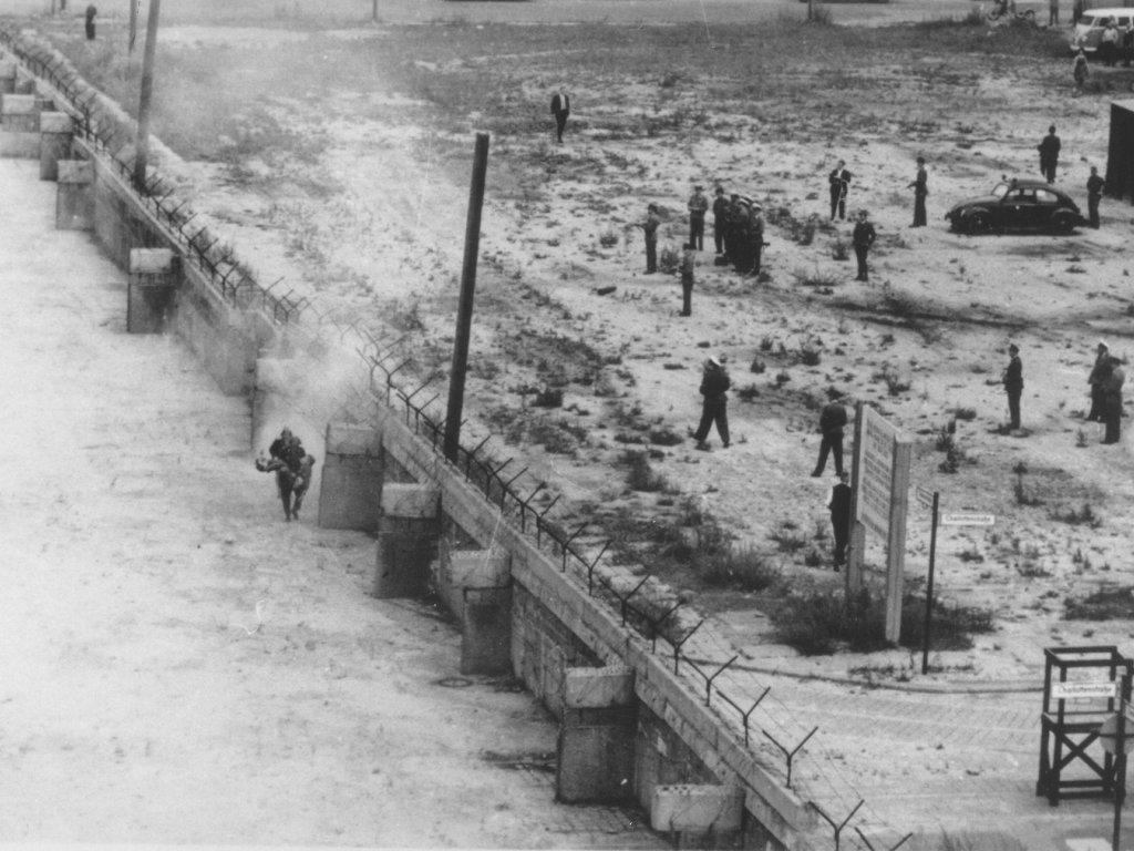 Peter Fechter, shot dead at the Berlin Wall: East German border guards retrieving the dying man from Zimmerstrasse near the Checkpoint Charlie border crossing (I) [Aug. 17, 1962]