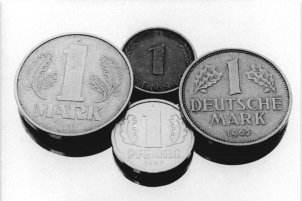 Bundeskanzler Kohl und Ministerratsvorsitzender de Maizière verhandeln über die Währungsunion, die schon im Juli in Kraft treten soll (v. l. n. r.: 1 Mark der DDR, 1 Pfennig Bundesrepublik und DDR, 1 Deutsche Mark); Aufnahme 24. April 1990