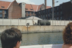 Berlin tourists can watch from the Spree as border soldiers remove signal elements from the Wall